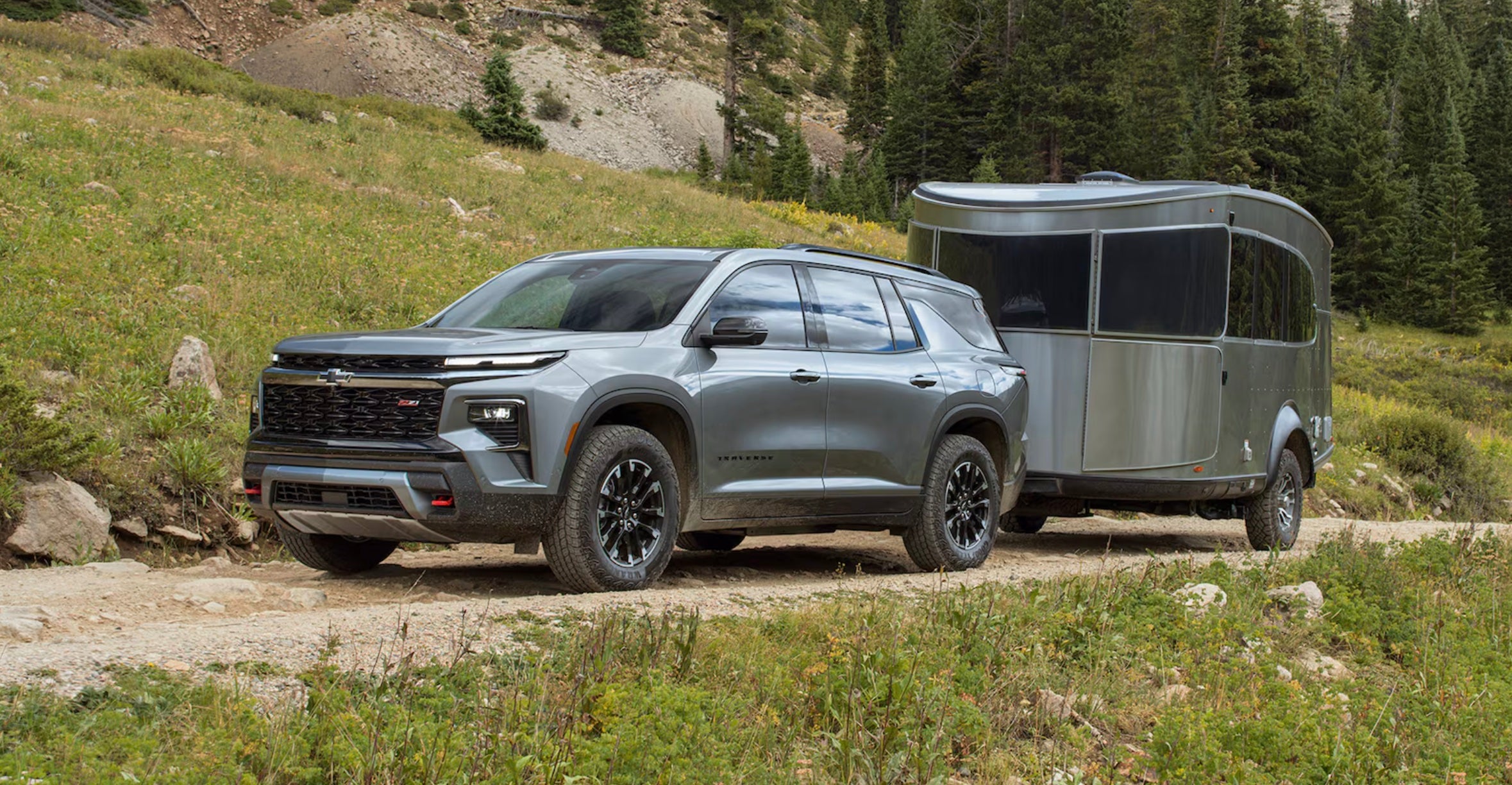 The 2024 Chevrolet Traverse avaliable at Lou Bachrodt Auto Mall towing a camper to a local KOA.